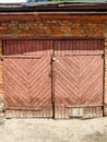 Pink wooden door to an old garage. Royalty Free Stock Photo