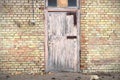 Pink wooden door in yellow brick wall building Royalty Free Stock Photo