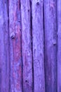 Pink wooden wall made of pine logs as the background texture. the logs are positioned vertically Royalty Free Stock Photo