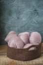 Pink wool yarn in the crocheted basket Royalty Free Stock Photo