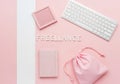 Pink workspace flat lay with keyboard and notebook isolated on white background Royalty Free Stock Photo