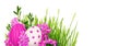 Pink yarrow flowers and Easter painted eggs with green grass