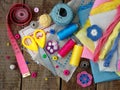 Pink, yellow and blue accessories for needlework on wooden background. Knitting, embroidery, sewing. Small business. Income from h Royalty Free Stock Photo