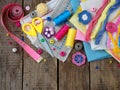 Pink, yellow and blue accessories for needlework on wooden background. Knitting, embroidery, sewing. Small business. Income from h Royalty Free Stock Photo