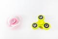 Pink and yellow color fidget spinner moving in a motion and still condition isolated in white background