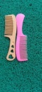 2 pink and yellow combs which are usually used to tidy up hair