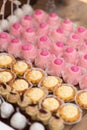 Pink and yellow cupcakes on banquet table. Royalty Free Stock Photo