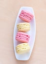 Pink and yellow macaron on a plate