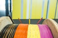 Pink, Yellow, Orange and Black Coated Cables on Wood Reel