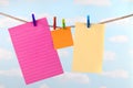 Pink, yellow and orange note paper on clothesline Royalty Free Stock Photo
