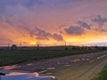 A pink orange purple sky with the sun at sunset with clouds before the rain Royalty Free Stock Photo