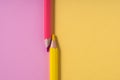 Pink and yellow pencils on pastel pink and yellow contrast background. education concept.top view.place for text Royalty Free Stock Photo