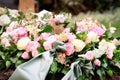 pink and yellow roses and gray-green ribbon on a grave Royalty Free Stock Photo