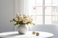 Pink and yellow roses in Modern white vase on white table beside classic armchair. Created with Generative AI technology Royalty Free Stock Photo