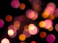 pink and yellow round soft glowing blurred lights abstract on a black background