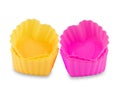 Pink and yellow silicone cupcake or muffin forms isolated on white background. Cake cup, silicone mold, bakeware. Royalty Free Stock Photo