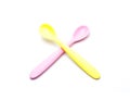 Pink and yellow silicone or plastic baby spoon