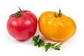 Pink and yellow tomatoes with parsley twig on white background Royalty Free Stock Photo