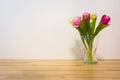 Pink Yellow Tulips Wooden Table White Wall Glass Vase