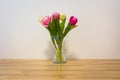 Pink Yellow Tulips Wooden Table White Wall Glass Vase