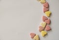 Pink and yellow Vitamins in the shape of a heart lie on a white background