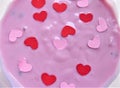 Pink yogurt with little decorative hearts love background Royalty Free Stock Photo