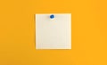 Pinned notepad sheet of square paper on isolated yellow background, for message and work letters Royalty Free Stock Photo