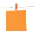 Pinned orange notepad isolated on white background