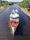 Pinned shot of a Finnish ship about to pass under a bridge in a lake