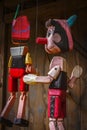 Pinocchio wooden puppet hanging outside as decoration Royalty Free Stock Photo