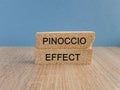 Pinoccio effect symbol. Concept words Pinoccio effect on brick blocks on a beautiful light blue background Royalty Free Stock Photo