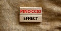 Pinoccio effect symbol. Concept words Pinoccio effect on wooden blocks on a beautiful canvas background. Business and Pinoccio Royalty Free Stock Photo