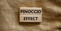 Pinoccio effect symbol. Concept words Pinoccio effect on wooden blocks on a beautiful canvas background. Business and Pinoccio Royalty Free Stock Photo