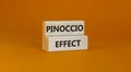 Pinoccio effect symbol. Concept words Pinoccio effect on wooden blocks on a beautiful orange background. Business and Pinoccio Royalty Free Stock Photo