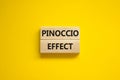 Pinoccio effect symbol. Concept words Pinoccio effect on wooden blocks on a beautiful yellow background. Business and Pinoccio Royalty Free Stock Photo