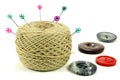Pins for sewing with the coil of threads and color buttons on a white background Royalty Free Stock Photo