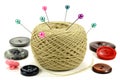 Pins for sewing with the coil of threads and color buttons on a white background Royalty Free Stock Photo