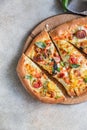 Pinsa with vegetables and cheese, concrete background. Traditional rome pizza. Top view