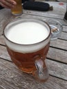 Pint of beer on bench table Royalty Free Stock Photo
