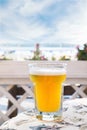 Pint of cold beer on the table in cafe, blurry background Royalty Free Stock Photo