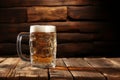 A pint of foaming beer in a glass on a peasant table. Rustic style