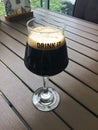 Pint glass with beer on black background, Glass of cold beer with foam