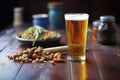 pint glass of craft beer with a bowl of mixed nuts on side Royalty Free Stock Photo