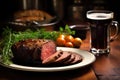 pint of stout beside a platter of prepared beef brisket