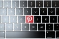 Pinterest icon on laptop keyboard. Technology concept