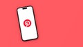 Pinterest Logo on Mobile Phone Screen on Red Background with Copy Space