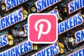 Pinterest paper logo on many Snickers chocolate covered wafer bars in brown wrapping. Advertising chocolate product in Pinterest