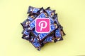 Pinterest paper logo on many Snickers chocolate covered wafer bars in brown wrapping. Advertising chocolate product in Pinterest