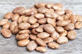 Pinto beans pile on wooden background.