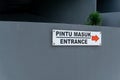 Pintu masuk mean Entrance. Entrance sign on the wall wrote in Bahasa pintu masuk